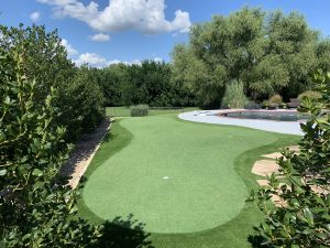 custom backyard putting green with synthetic turf
