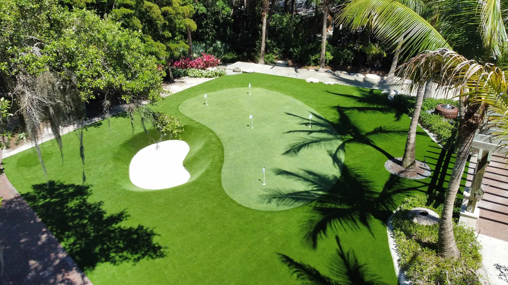 putting green in backyard with palm trees