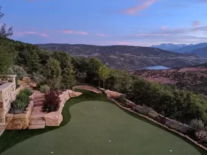 beautiful putting green installed on a backyard that outlooks a plateau